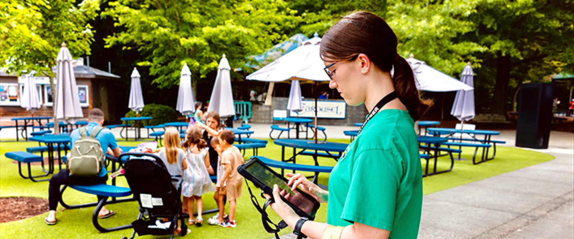 An intern at the Zoo reviewing a guest survey on a tablet.