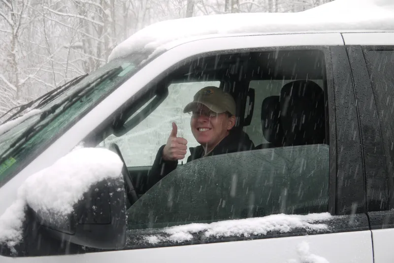 Ranger giving a thumbs up in vehicle in a snow storm