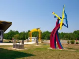 Spalazani's Generator, a colorful kinetic steel sculpture, in front of the Zoo's Solar Pointe picnic area.