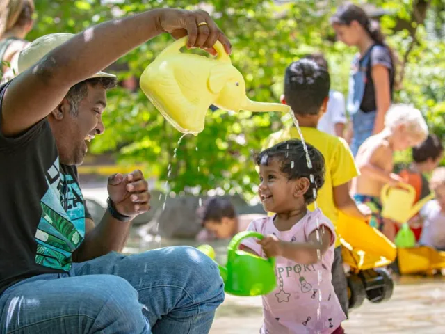 A father plays with his young daughter in the Kidzone Play Stream.