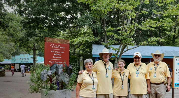 Five Zoo volunteers posing for the camera in Africa Plaza.
