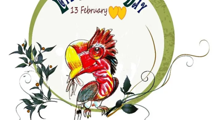 A stylized cartoon hornbill with a large yellow-tipped casque, red and pink head, and long tail feathers is perched on a branch. The text "LOVE Hornbills DAY" is arched in green and blue text above the bird, with "13 February" and two yellow hearts underneath. The image is framed by a green circle and decorative vines with dark leaves and small orange berries.