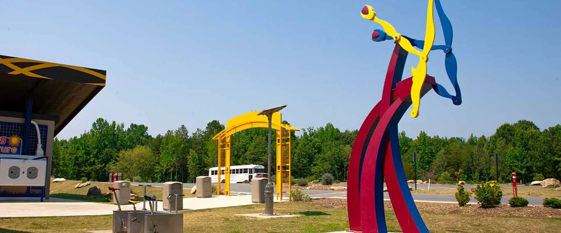Spalazani's Generator, a colorful kinetic steel sculpture, in front of the Zoo's Solar Pointe picnic area.