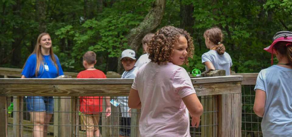 campers following counselor through the zoo  