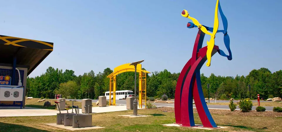 Spalazani's Generator, a colorful kinetic steel sculpture, in front of the Zoo's Solar Pointe picnic area.