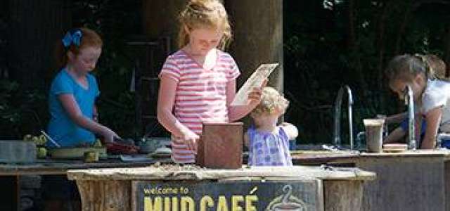 A child plays at the "Mud Cafe"
